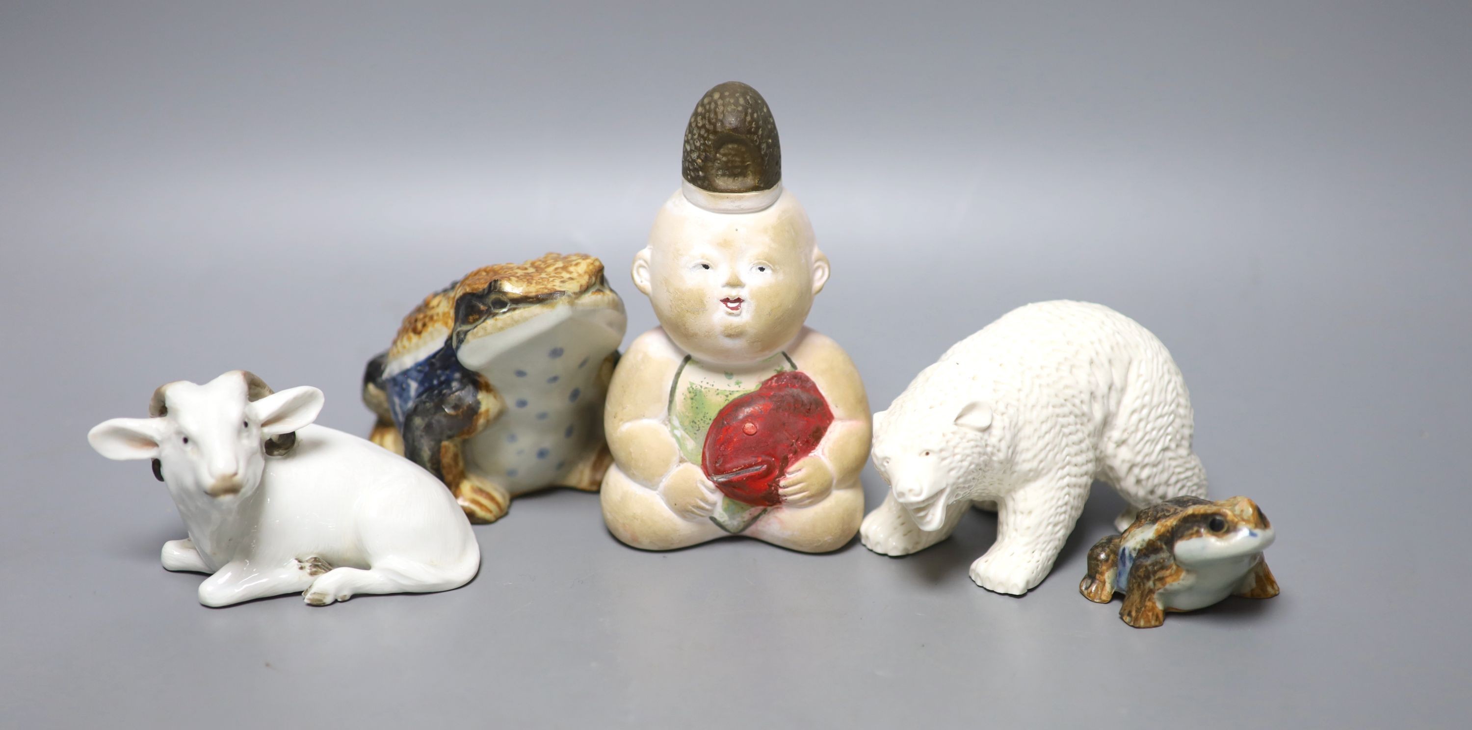 A Japanese Hirado porcelain figure of a polar bear, a Japanese porcelain figure of a ram, two figures of toads and a doll figure